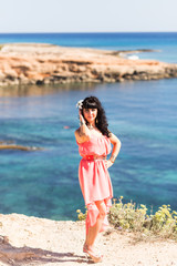 Fototapeta na wymiar woman in a dress on the ocean coast