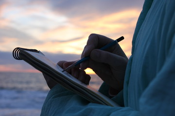 Drawing on the waterfront in sunset