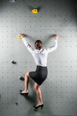 Pretty female office worker on training wall