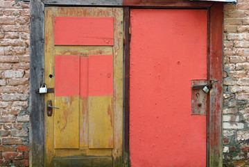 Fototapeta na wymiar Two old colorful wooden door with peeling paint and background for text