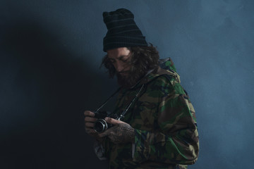 Vintage photographer with beard and long hair wearing camouflage