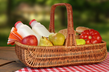 Picnic Basket With Food And Drink On The Table