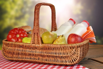 Picnic Basket With Food And Drink On The Table