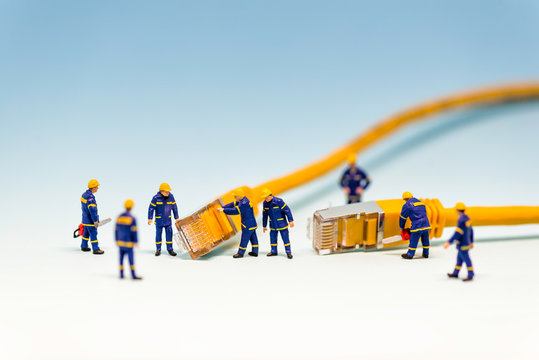 Team of techs with RJ45 network cable - Powered by Adobe