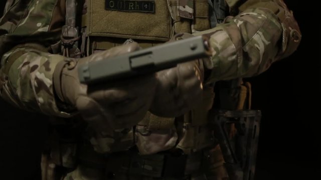 Soldiers in camouflage gear checks. Close-up