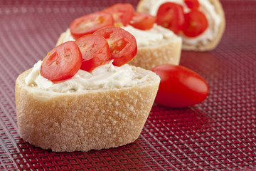 bread slices with cream cheese and tomato slices