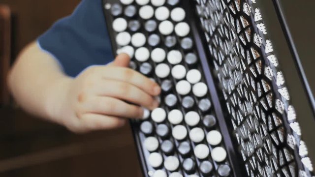  child playing the accordion. close-up