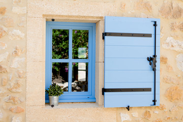 blue old window in traditional french provence architecture