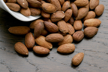 a bowl with spilled almonds
