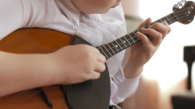 child plays the domra