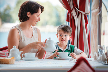 Mother and son having breakfast together at cafe