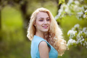 Naklejka premium beautiful young blonde woman looks around, smiling.