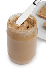 open jar of peanut butter with knife