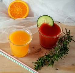 Two glasses of fresh smoothie with orange and tomato