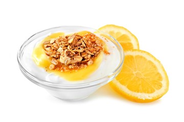 Clear bowl of lemon flavored yogurt and granola with lemon slices over a white background