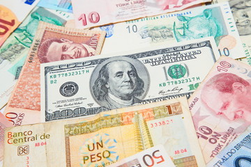 Fototapeta na wymiar Background from paper money of the different countries. American dollars in the middle