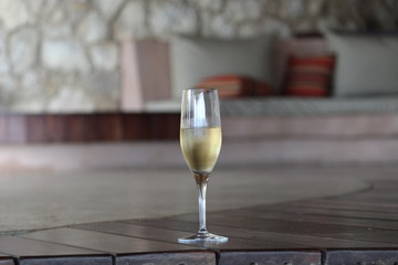 A glass of champagne in a beige colored lounge setting