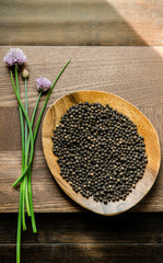 Peppercorn on acacia wood with chives
