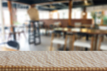 Selected focus empty brown wooden table and Coffee shop blur bac