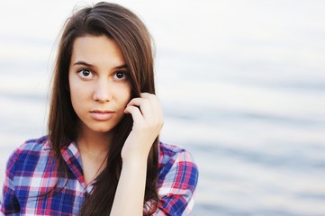 beautiful brunette girl in a plaid shirt