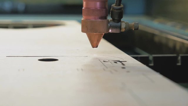 Laser cutting machine at work, close up, rack focus