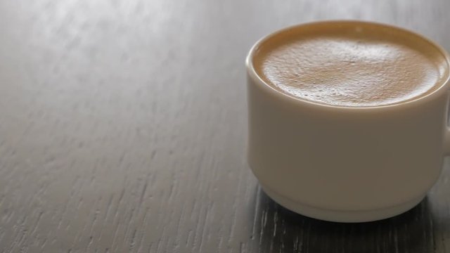 Espresso coffee cup on table panning 4K 2160p UHD video - Delicious coffee cream in the cup 4K 3840X2160 UHD footage 