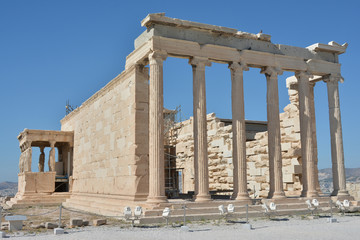 Fototapeta premium Erechtheion ancient greek temple dedicated to both Athena and Poseidon, with the famous Porch of Caryatids, at the top of the Acropolis of Athens