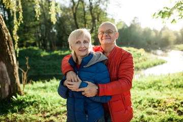 happy seniors couple embrace and smile;