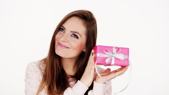 Woman shaking present pink gift box 4K