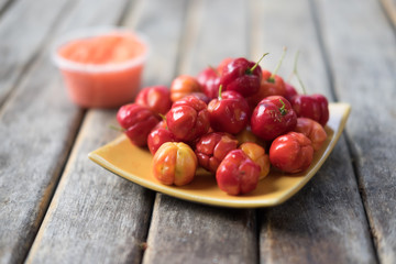 Fresh red barbados cherry on wood table