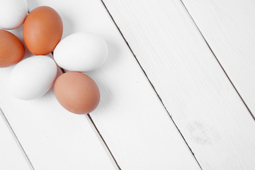 Fresh chicken eggs on wood background. Copy space. Top view
