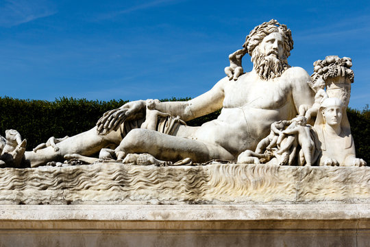 Color DSLR image of ancient statue of reclining man in Tuileries Garden, Paris, France. Horizontal with copy space for text.