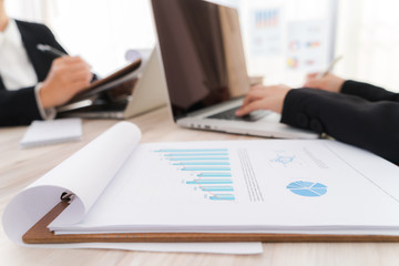 Business people using laptop  and Financial charts  at meeting o