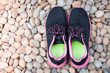 Running shoes in home garden on pebbles