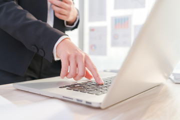 Closeup of business woman hand typing on laptop keyboard
