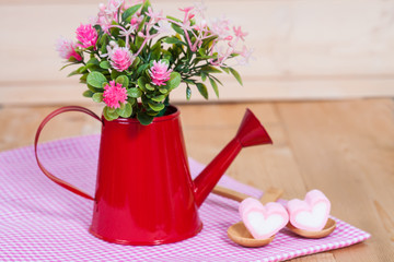 flowers in red watering on wood