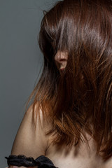 Closeup of a freckled woman behind her hair