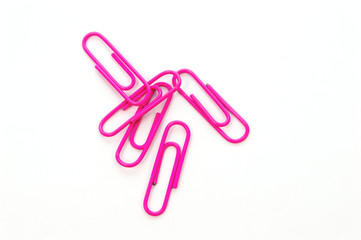 Pink paper clip on white background
