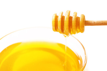 Honey in a bowl and dipper