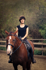 Happy Horsewoman Ridding  in a Manege