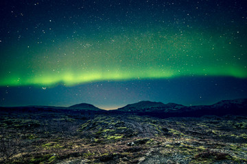 Aurora Borealis over distant mountains