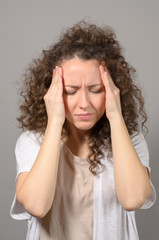 Young woman suffering from a terrible headache