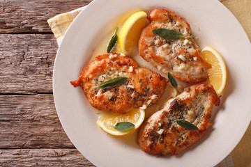 Tasty chicken steaks with sage, lemon and garlic sauce closeup. horizontal top view 
