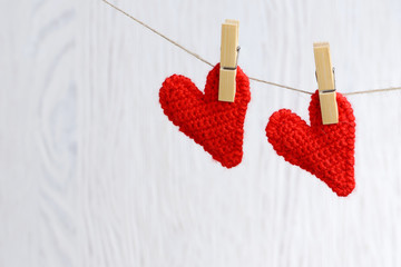 red hearts hanging on wooden background