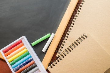Crayon, blackboard and book