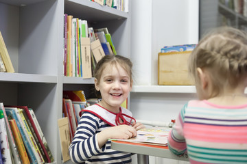 Fototapeta premium girls in children's library