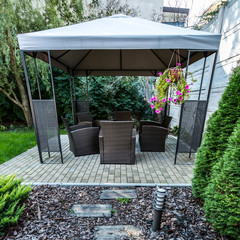 Vertical view of beauty garden with wicker furniture