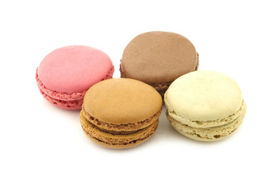 assorted freshly baked macarons on a white background
