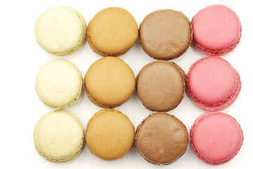 assorted freshly baked macarons on a white background