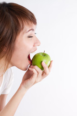 healthy asian woman on border, biting or eating green apple